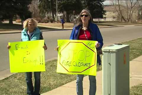 Protesters gather outside Green Valley Ranch HOA office following foreclosures